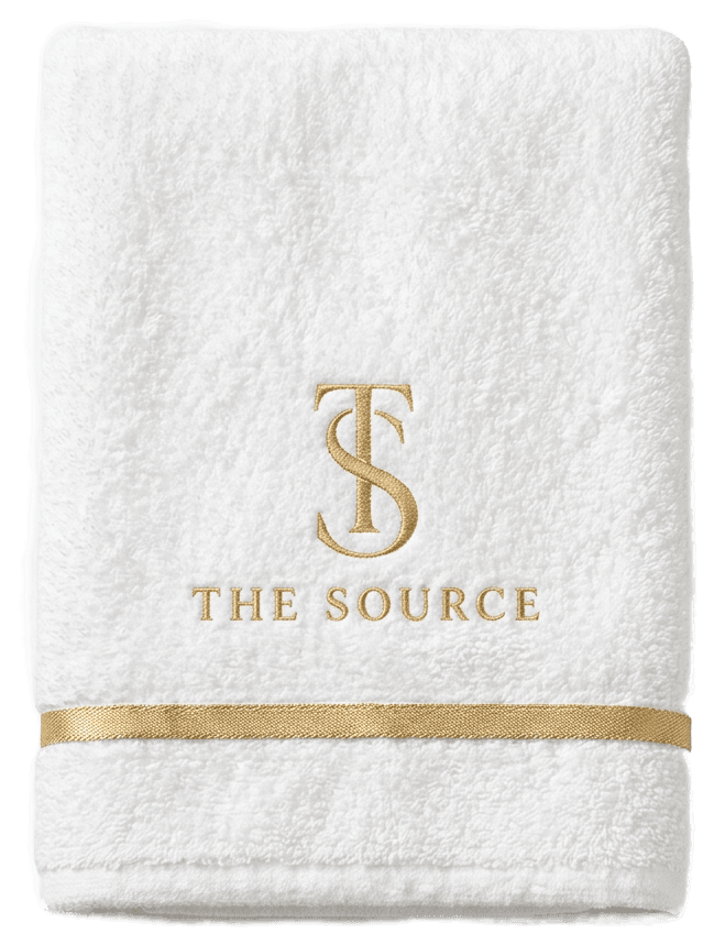 The Source folded towel in white with a gold monogram band