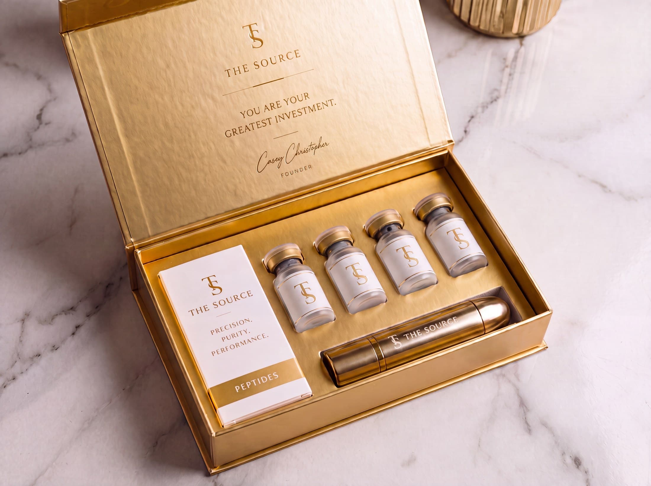 The Foundations Kit — gold-interior box holding four house vials and the engraved travel vessel